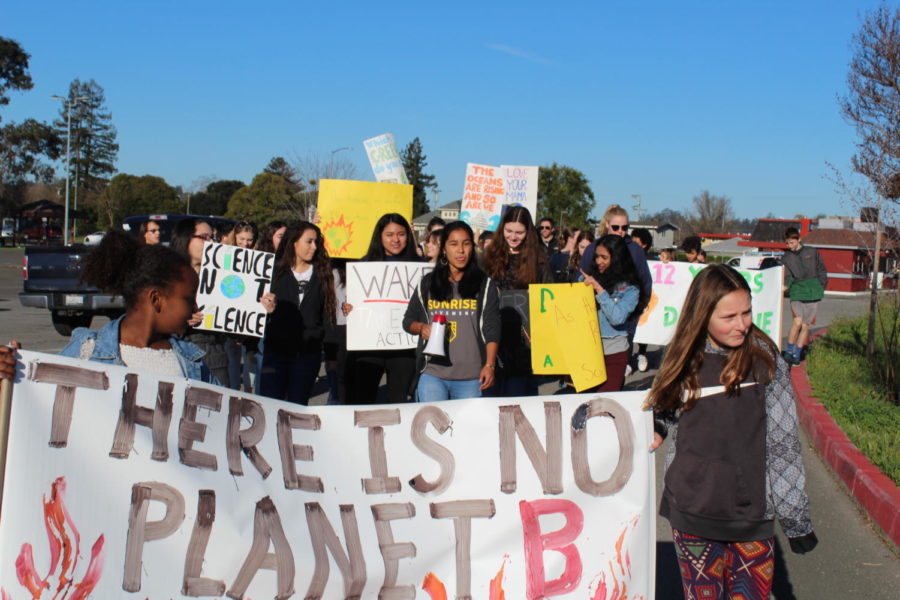 Live Oak Elementary School and Casa Grande High School students walk together through the streets of Petaluma to advocate for climate change. 